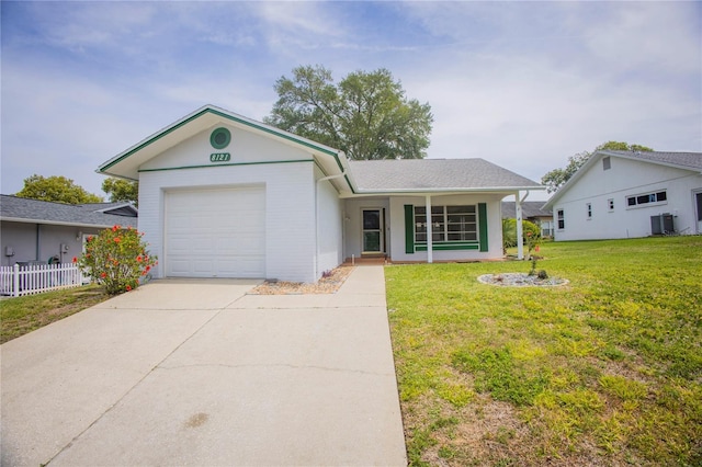 ranch-style home with central AC unit, a front yard, and a garage