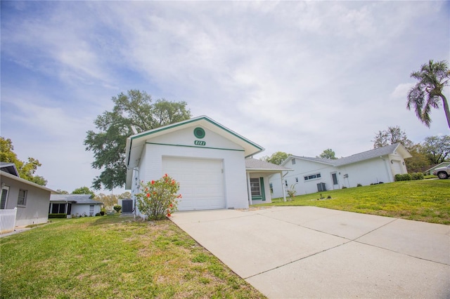 single story home featuring a front lawn and a garage