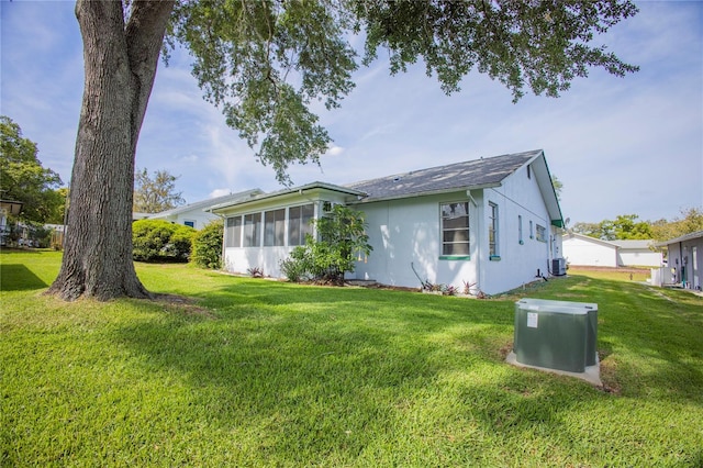 rear view of property with a lawn