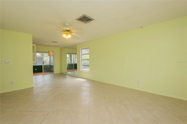 unfurnished room with ceiling fan and light tile patterned flooring