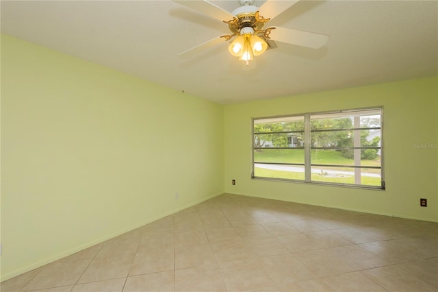 spare room featuring ceiling fan and light tile patterned flooring