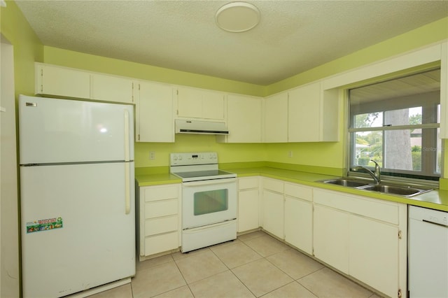 kitchen with light tile patterned floors, white cabinets, white appliances, and sink