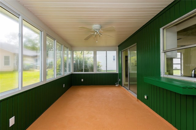 unfurnished sunroom with ceiling fan and a wealth of natural light