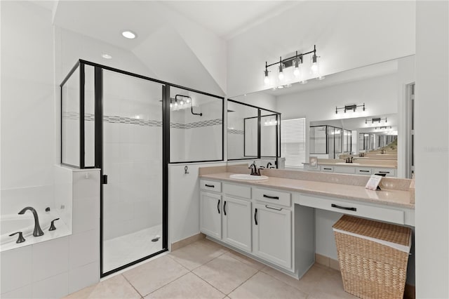 bathroom with shower with separate bathtub, vaulted ceiling, double sink vanity, and tile floors