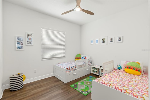 bedroom with dark hardwood / wood-style floors and ceiling fan