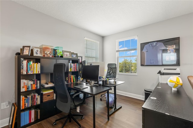 office space with hardwood / wood-style floors and a textured ceiling