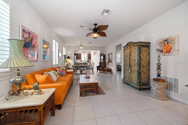 living room with ceiling fan, a healthy amount of sunlight, and light tile patterned floors