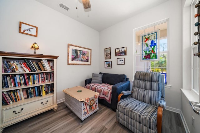 sitting room with dark hardwood / wood-style floors and ceiling fan