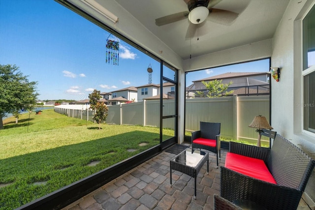 sunroom / solarium featuring ceiling fan