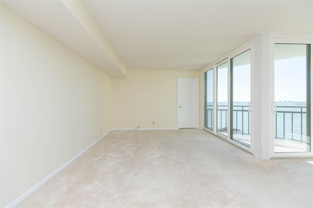 empty room with carpet floors and a water view