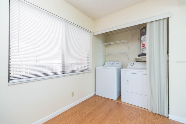 washroom featuring washer and clothes dryer and light hardwood / wood-style floors