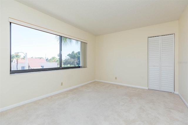 unfurnished bedroom with a closet and carpet flooring