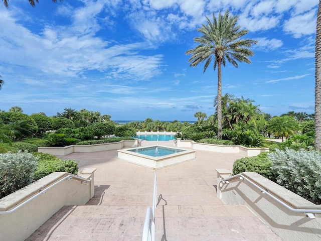 view of swimming pool with an in ground hot tub and a patio area