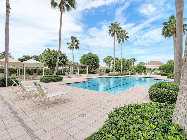 pool featuring a pergola and a patio area
