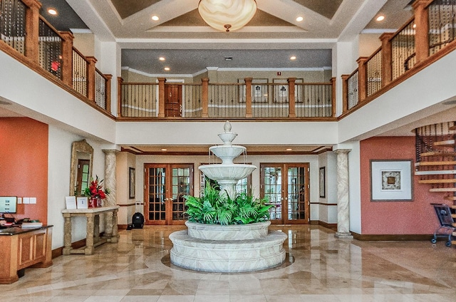 foyer entrance featuring baseboards, crown molding, and french doors