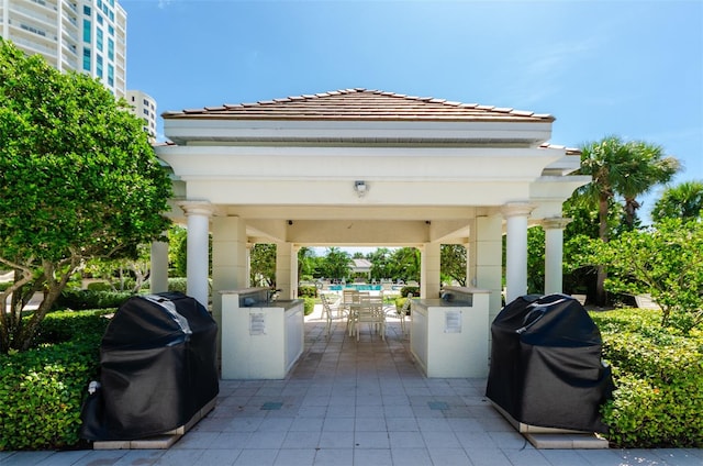 view of patio / terrace featuring outdoor dining space, a gazebo, and grilling area