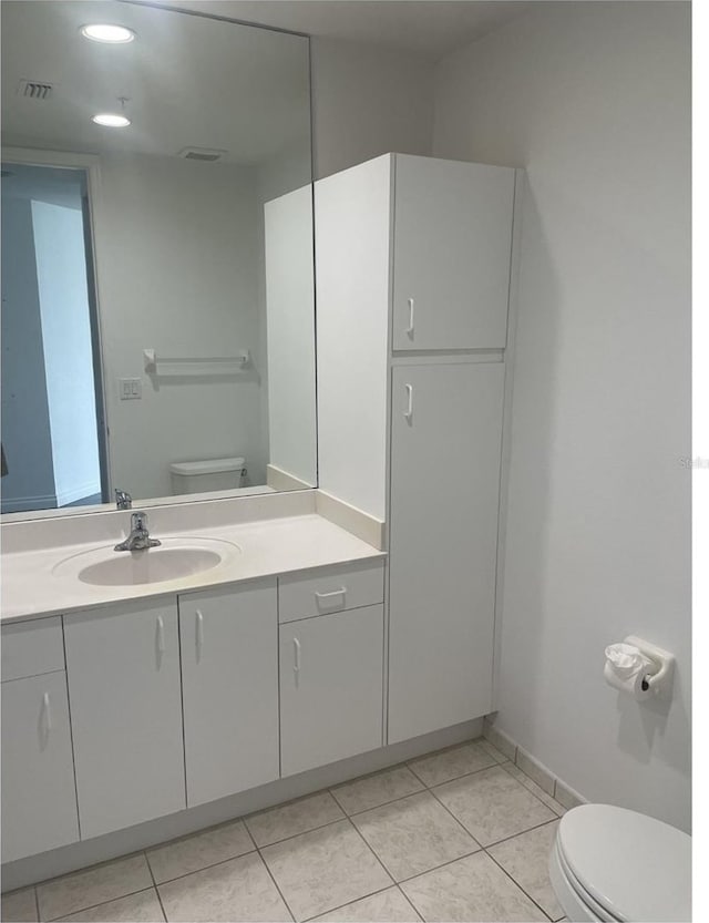 bathroom featuring visible vents, toilet, tile patterned flooring, and vanity
