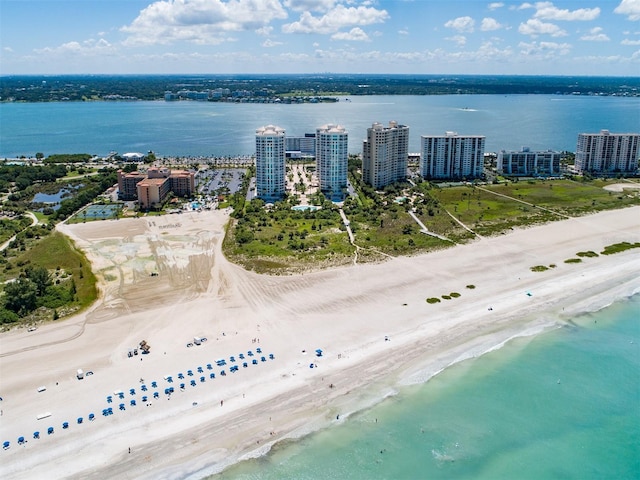 aerial view with a view of the beach, a water view, and a view of city