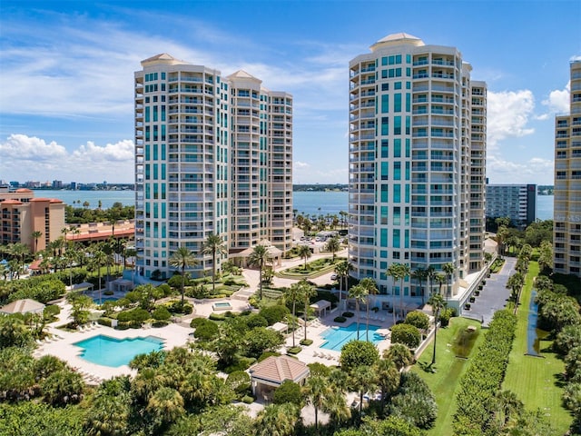 exterior space with a city view and a water view