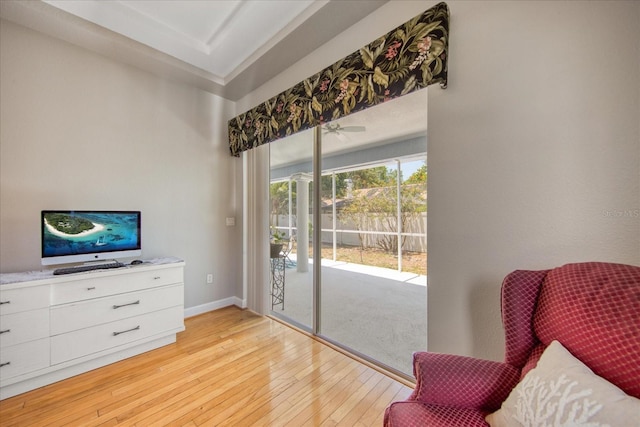 sitting room with ceiling fan and light wood-type flooring