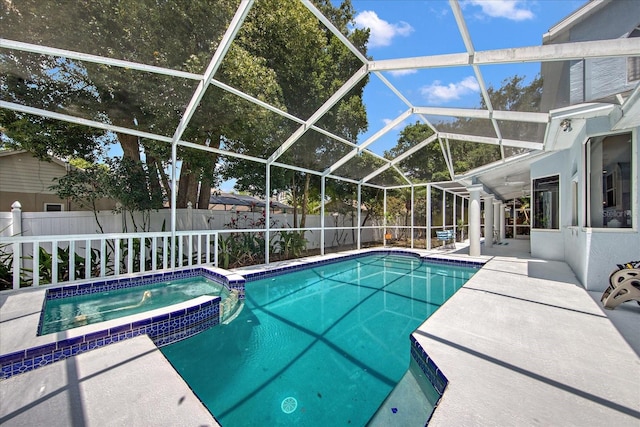 view of swimming pool with a patio area, a lanai, and an in ground hot tub