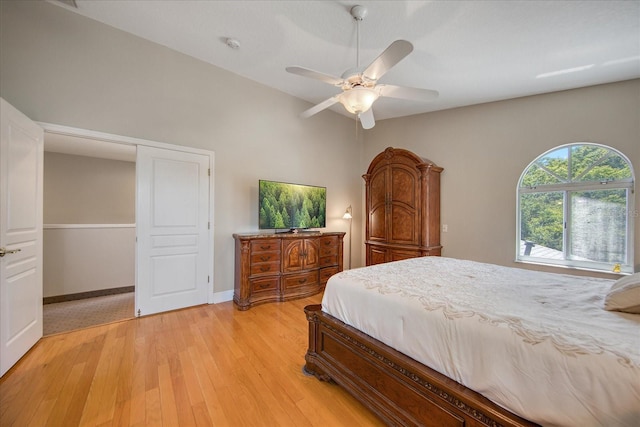 bedroom featuring ceiling fan, light hardwood / wood-style floors, and a closet