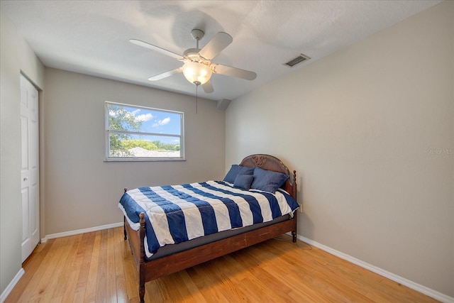 bedroom with ceiling fan, a closet, and light wood-type flooring