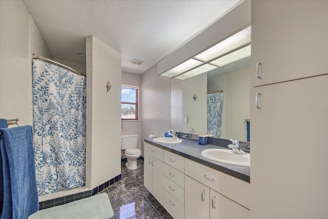 bathroom featuring vanity, a textured ceiling, toilet, and a shower with shower curtain