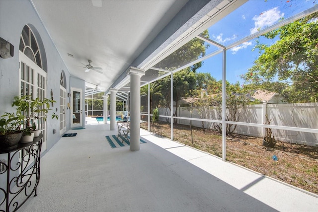 view of patio featuring ceiling fan, a fenced in pool, and glass enclosure