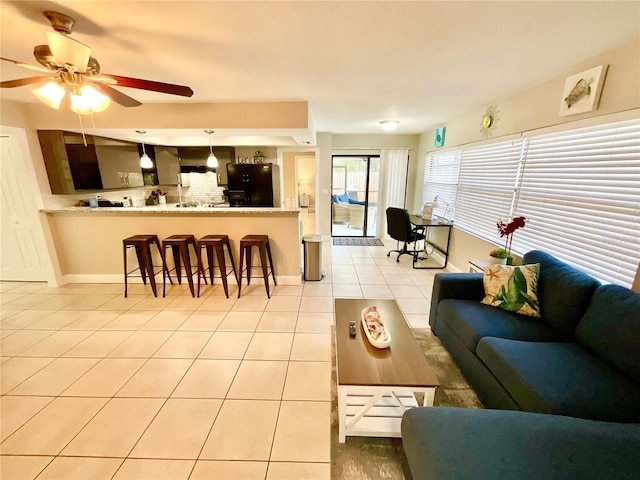 living room featuring ceiling fan and light tile patterned flooring