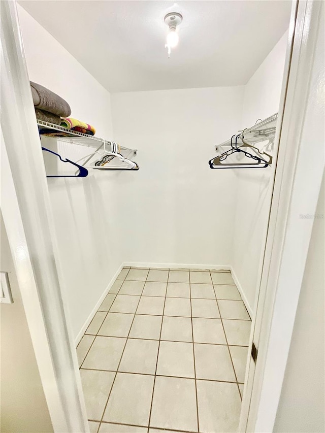 spacious closet featuring light tile patterned flooring