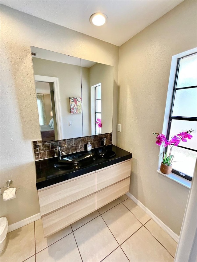 bathroom featuring tile patterned flooring, vanity, and a wealth of natural light