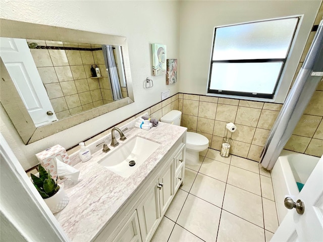 full bathroom with vanity, shower / bath combo, tile patterned flooring, toilet, and tile walls