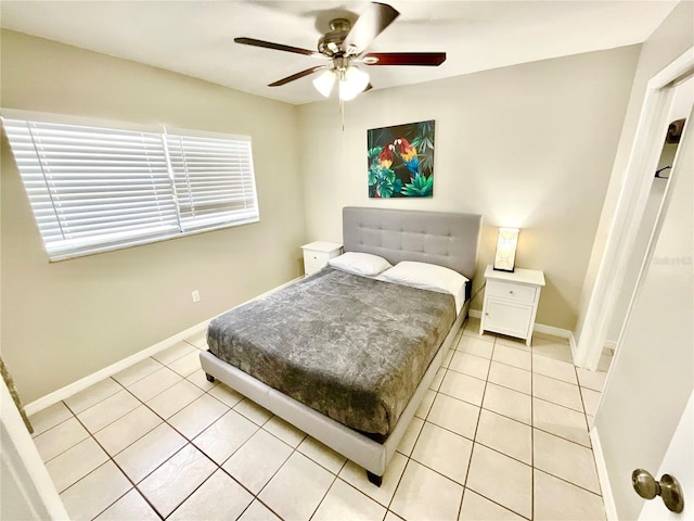 bedroom with ceiling fan and light tile patterned floors