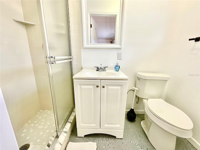 bathroom with toilet, an enclosed shower, and vanity