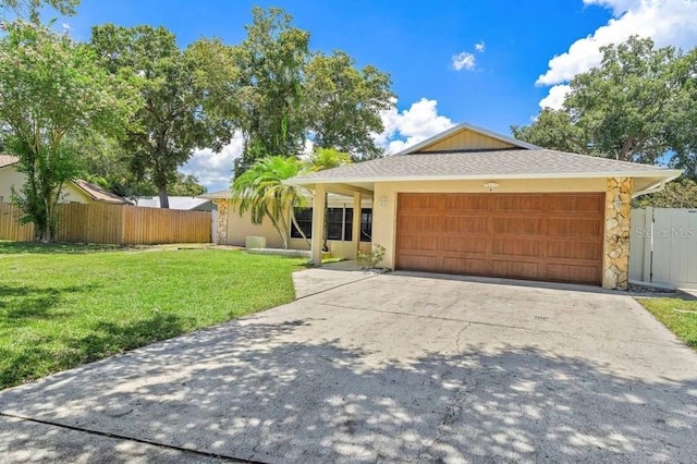 ranch-style house featuring a front lawn and a garage