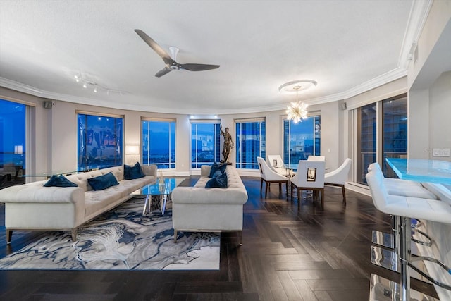 living room featuring ceiling fan with notable chandelier, ornamental molding, and dark parquet floors