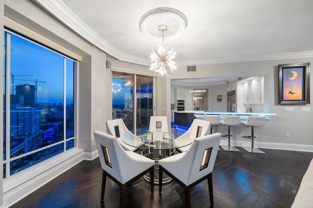 dining area with crown molding, dark parquet floors, a textured ceiling, and an inviting chandelier