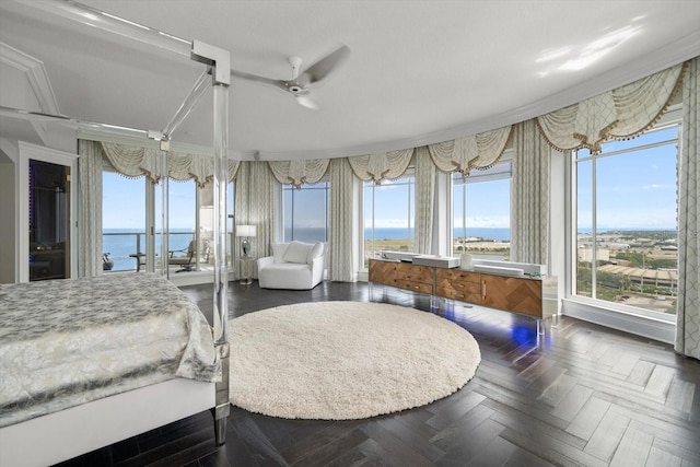 bedroom featuring dark parquet flooring, ceiling fan, crown molding, and a water view