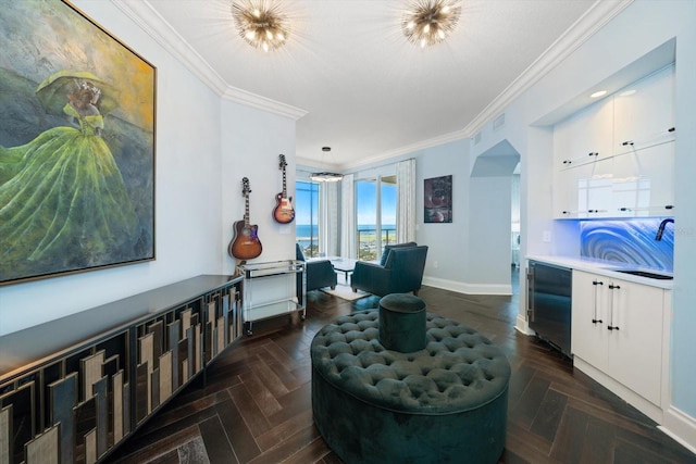 sitting room featuring dark parquet floors, ornamental molding, and sink