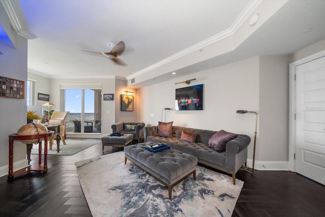 living room with dark parquet flooring, ceiling fan, and crown molding