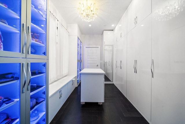 spacious closet featuring an inviting chandelier