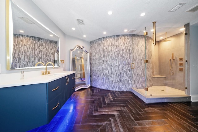 bathroom with vanity, a shower with shower door, and parquet floors