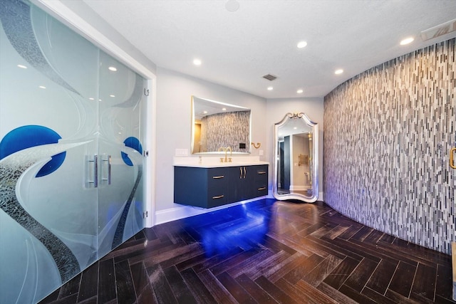 bathroom with vanity and parquet floors