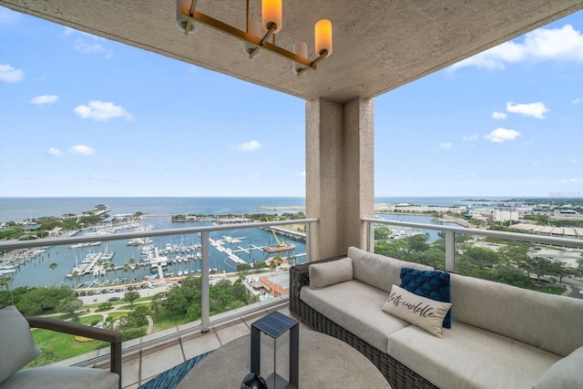 balcony featuring outdoor lounge area and a water view