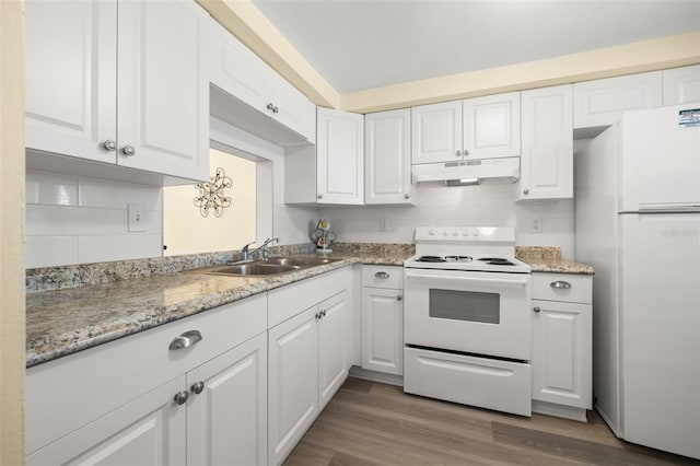 kitchen featuring tasteful backsplash, white appliances, wood-type flooring, sink, and white cabinets