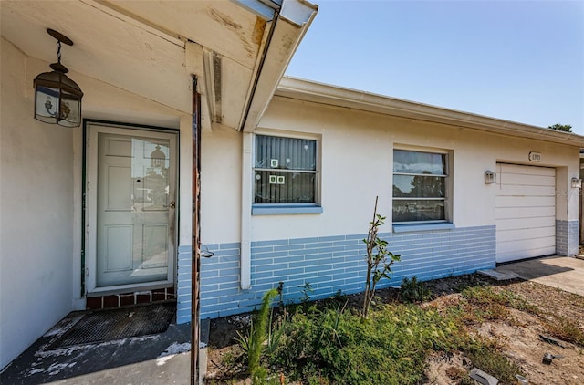 view of exterior entry featuring a garage