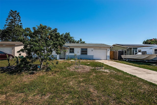 view of front of home with a front yard and a garage