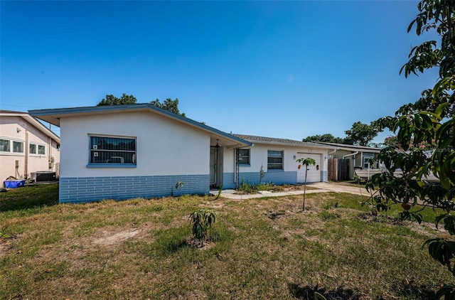 view of front of home featuring a front lawn and central AC unit