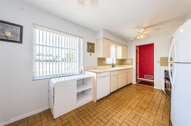 kitchen featuring ceiling fan, tasteful backsplash, white cabinets, sink, and white appliances